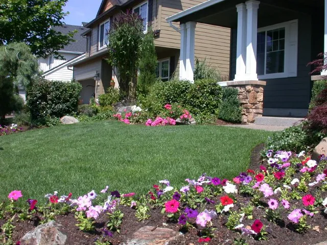 Colorful front-yard planting beds and fresh lawn