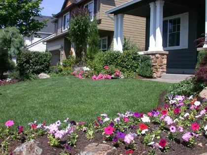Colorful front-yard planting beds and fresh lawn