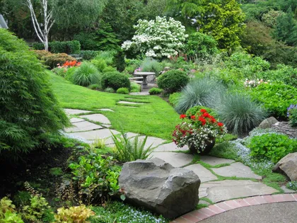 Flagstone path winding through lush planting beds