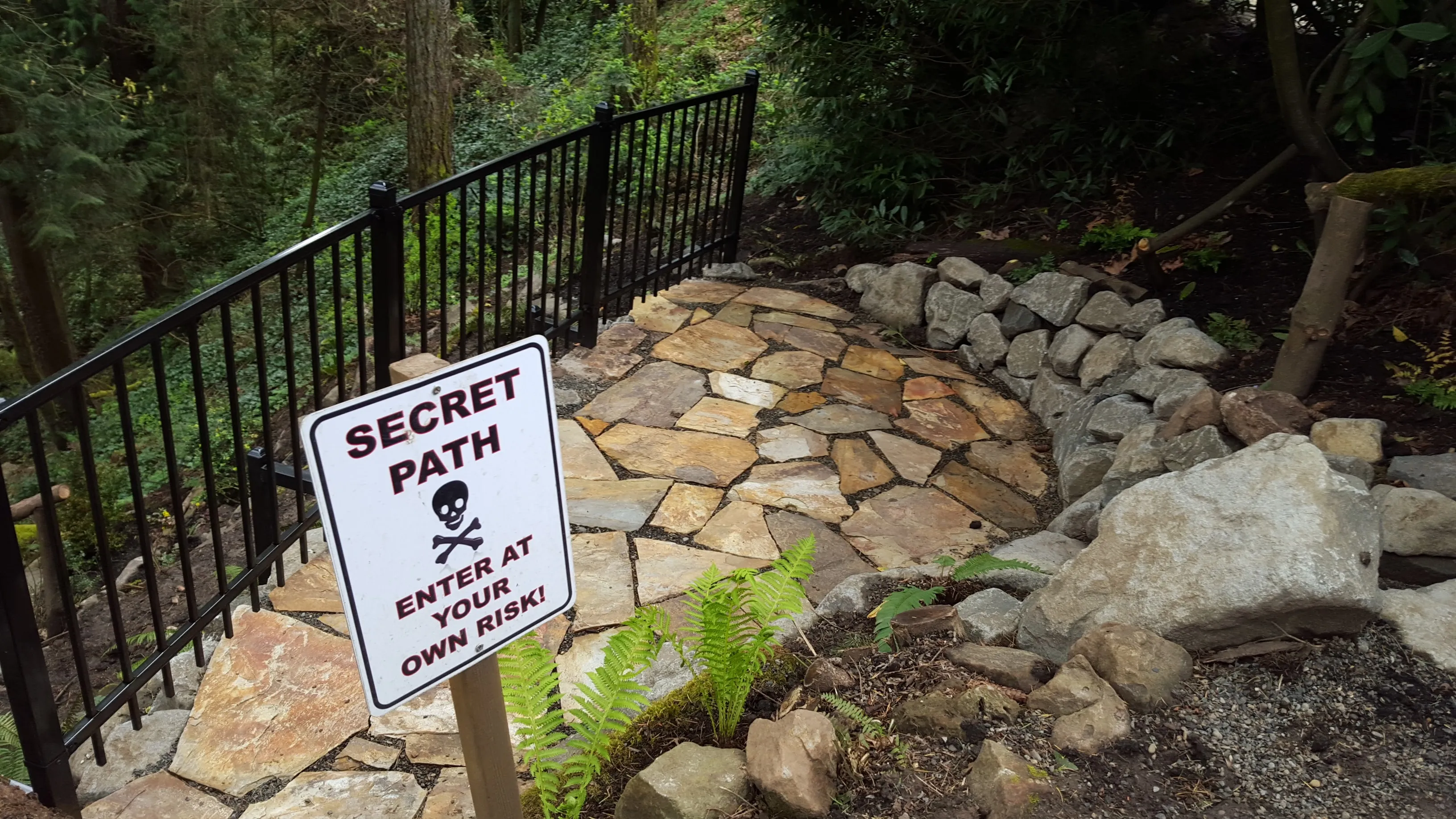 New flagstone circle with the homeowner’s "Secret Path" sign