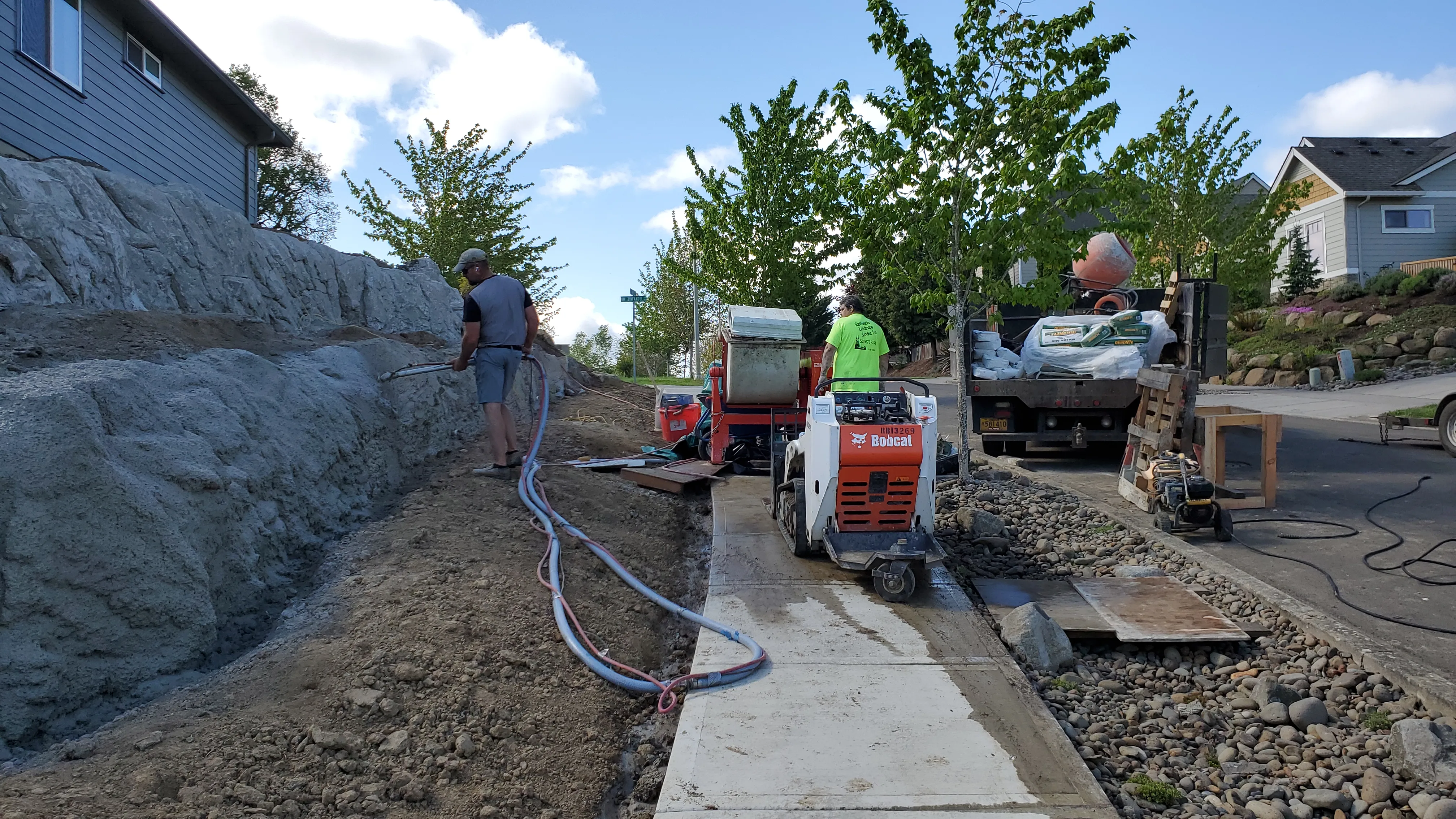 Crew, pump hoses, and equipment lined along the lower wall during the concrete pour