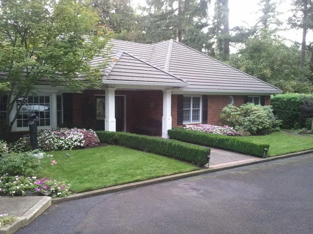 Manicured Lake Oswego frontage with boxwood spheres and crisp lawn edges